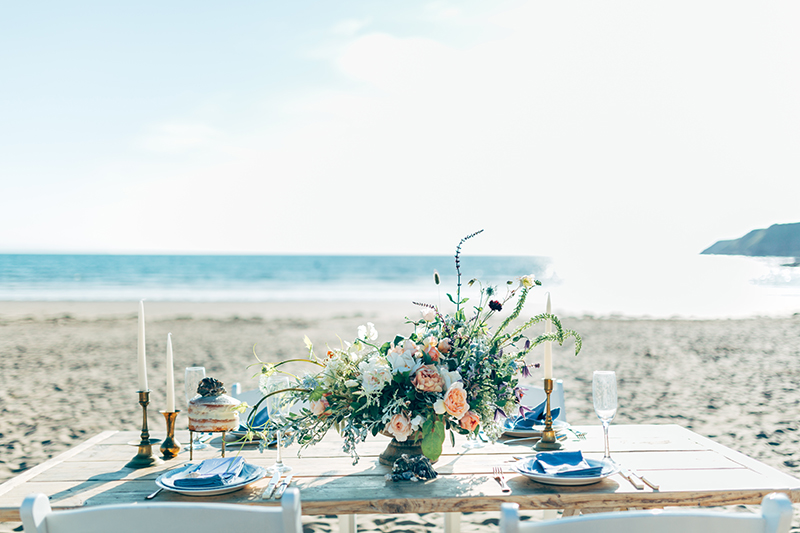beach wedding table with floral centrepiece