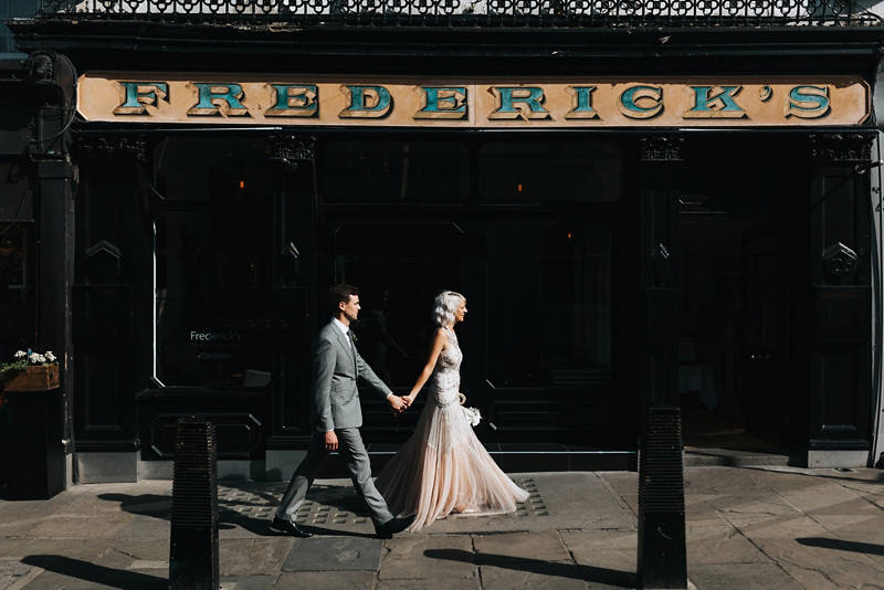 bride and groom outside fredericks in Angel, Islington london by wedding photographer Miss Gen
