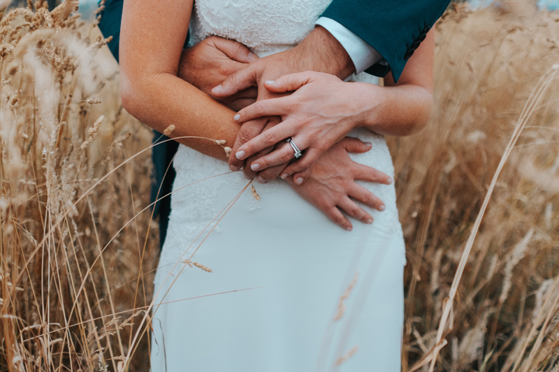 bride and groom in field by modern australia wedding photographer Miss Gen