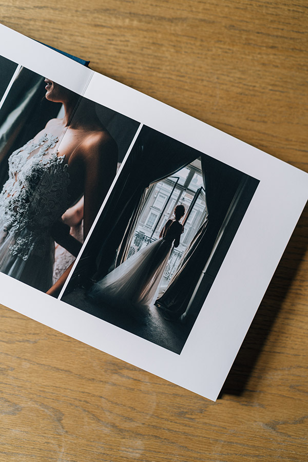Inside spread from a Fine Art Wedding Album by Miss Gen showing a bride in the window of her Chelsea house before her wedding at Chelsea Old Town Hall in London.