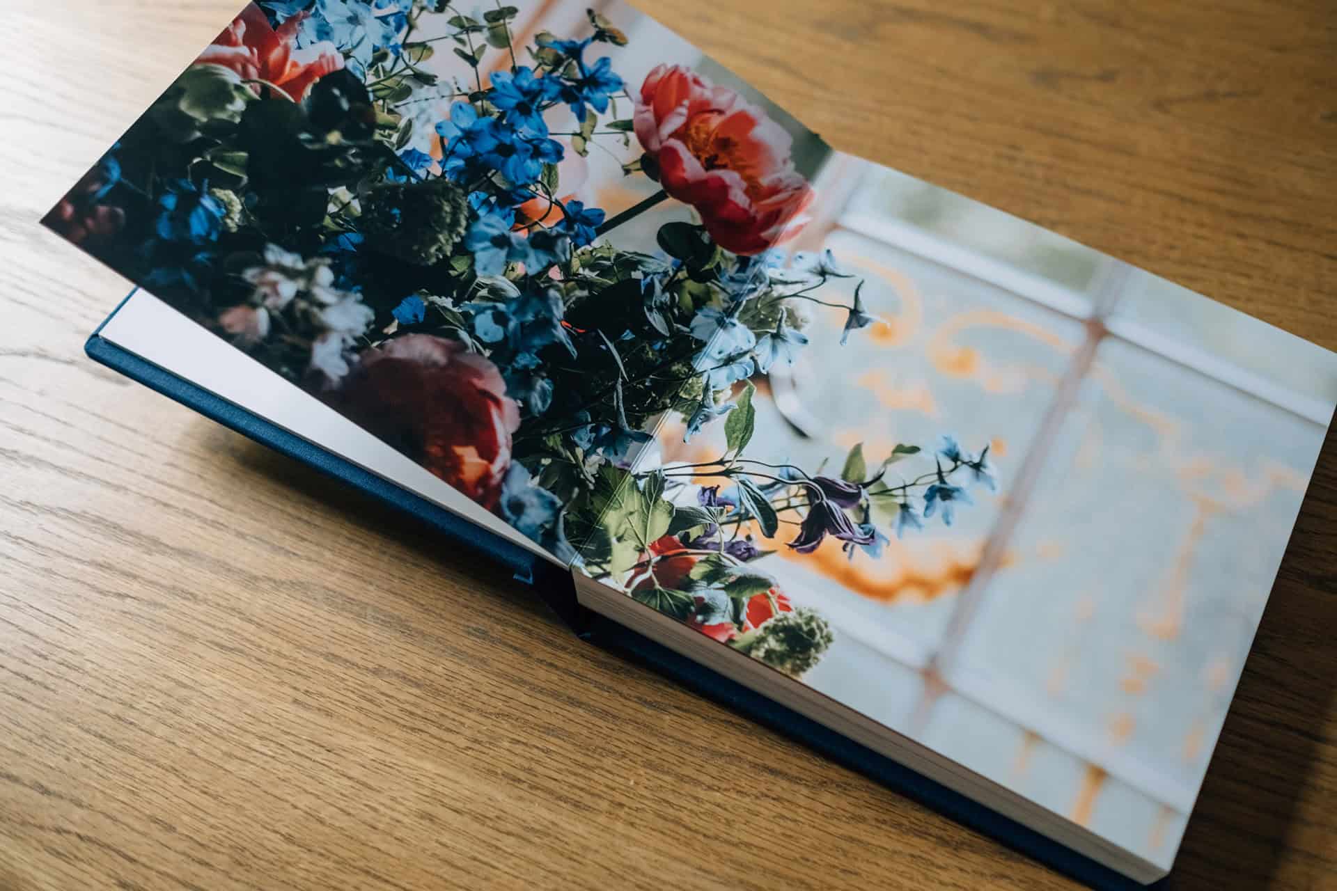 A spread showing flowers and a window from a beautiful timelss wedding photo album from an elopement at Islington Town Hall in London.