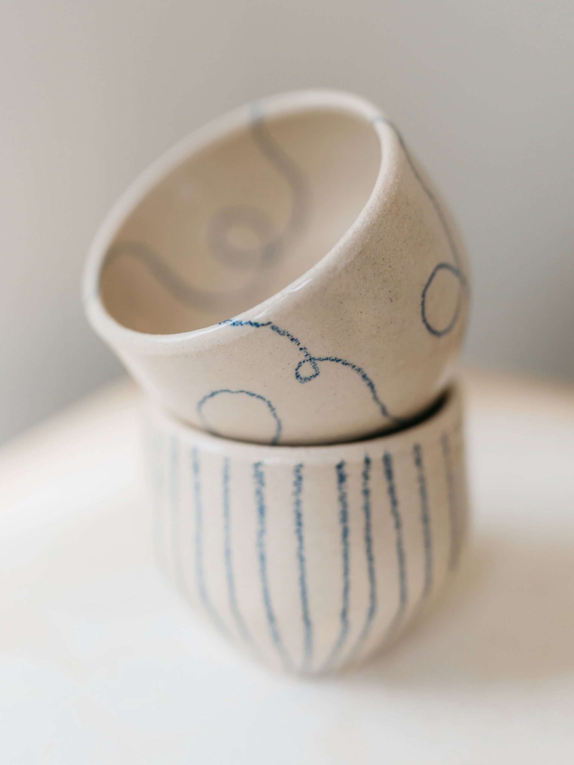 stoneware ceramic cups with pencil artist line decoration by Genevieve of miss gen ceramics